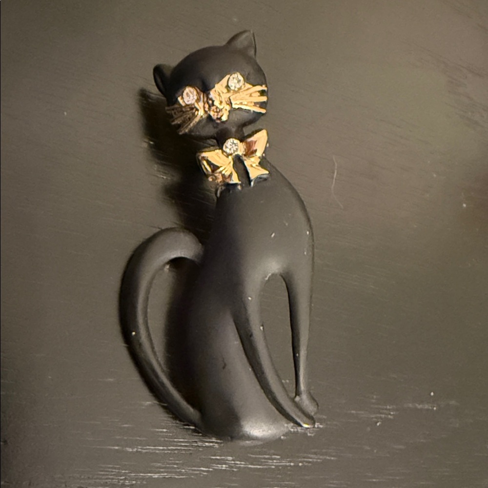 vintage matte black enamel cat brooch w/gold-tone whiskers, a rhinestone bow tie
